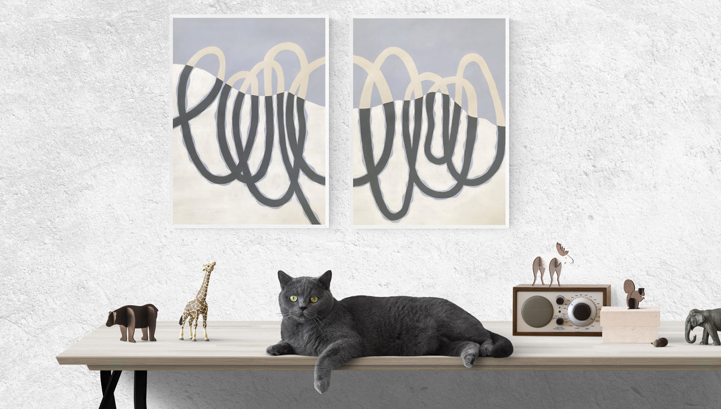 Loop paintings with cat sitting near by